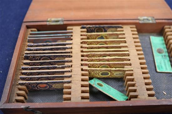 A cased microscope and a cased set of microscope slides